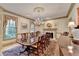 Formal dining room featuring a large table, chandelier, fireplace, and elegant decor, perfect for entertaining at 5884 Hammersmith Rd, Stone Mountain, GA 30087