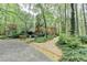 Beautiful brick home surrounded by lush greenery and mature trees, showcasing a tranquil setting at 5884 Hammersmith Rd, Stone Mountain, GA 30087