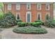 Elegant brick home featuring manicured landscaping and a brick pathway, creating a welcoming curb appeal at 5884 Hammersmith Rd, Stone Mountain, GA 30087