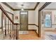 Foyer with hardwood floors, traditional staircase, and neutral decor, creating a warm and inviting entrance at 5884 Hammersmith Rd, Stone Mountain, GA 30087
