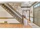 Entryway featuring hardwood floors, a classic staircase, and a view into other rooms, showcasing an open design at 5884 Hammersmith Rd, Stone Mountain, GA 30087