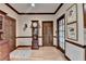 Inviting hallway featuring wood doors, traditional decor, and hardwood floors at 5884 Hammersmith Rd, Stone Mountain, GA 30087