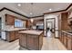 Bright kitchen featuring stainless steel appliances, wooden cabinetry, and kitchen island with sink at 5884 Hammersmith Rd, Stone Mountain, GA 30087