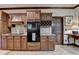 Well-appointed kitchen with built in range, wooden cabinetry, and granite countertops at 5884 Hammersmith Rd, Stone Mountain, GA 30087