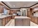 Bright kitchen featuring stainless steel appliances, kitchen island with sink, and wooden cabinetry at 5884 Hammersmith Rd, Stone Mountain, GA 30087