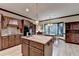 Bright kitchen with stainless steel sink in kitchen island, light wood floors, and wooden cabinets at 5884 Hammersmith Rd, Stone Mountain, GA 30087