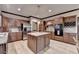 Spacious kitchen featuring stainless steel appliances, kitchen island with sink, and wooden cabinetry at 5884 Hammersmith Rd, Stone Mountain, GA 30087