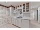 Modern basement kitchenette with white cabinets, stainless sink, and sleek countertops at 5884 Hammersmith Rd, Stone Mountain, GA 30087