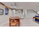 Bright basement kitchenette with eat in dining area, white cabinets, and modern appliances at 5884 Hammersmith Rd, Stone Mountain, GA 30087