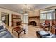 Spacious living room featuring a brick fireplace, and a comfortable seating area, perfect for relaxation at 5884 Hammersmith Rd, Stone Mountain, GA 30087
