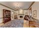 Cozy living room featuring a fireplace, display case, and a patterned rug, creating an inviting atmosphere at 5884 Hammersmith Rd, Stone Mountain, GA 30087