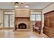 Living room with a brick fireplace, windows, and comfortable seating, offering a cozy and inviting atmosphere at 5884 Hammersmith Rd, Stone Mountain, GA 30087