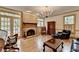 Inviting living room with a brick fireplace, windows, and a seating arrangement, perfect for relaxing at 5884 Hammersmith Rd, Stone Mountain, GA 30087