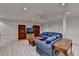 Open basement living room features comfortable seating, hardwood floors, and recessed lighting at 5884 Hammersmith Rd, Stone Mountain, GA 30087