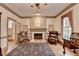 Living room featuring a fireplace, large window, and a patterned rug, offering a warm and inviting space at 5884 Hammersmith Rd, Stone Mountain, GA 30087