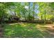 A well-maintained backyard with a deck, fire pit area, and a spacious lawn at 2336 Armand Ne Rd, Atlanta, GA 30324