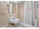 Cozy bathroom featuring a shower over the tub, patterned wallpaper, and stylish fixtures at 2336 Armand Ne Rd, Atlanta, GA 30324