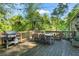 Outdoor deck with a table and chairs, grill, heat lamp, and string lights for daytime entertainment at 2336 Armand Ne Rd, Atlanta, GA 30324