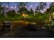 Outdoor deck with a table and chairs, grill, heat lamp, and string lights for evening entertainment at 2336 Armand Ne Rd, Atlanta, GA 30324