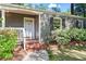 Close-up view of the front entrance with a brick stoop, storm door, and well-maintained landscaping at 2336 Armand Ne Rd, Atlanta, GA 30324