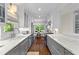 Bright kitchen with white and gray cabinets, marble countertops, and hardwood floors at 2336 Armand Ne Rd, Atlanta, GA 30324