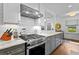 Modern kitchen includes a stainless steel range and a view into another living area at 2336 Armand Ne Rd, Atlanta, GA 30324