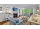 Bright and airy living room with a fireplace, French doors, and comfortable seating arrangement at 2336 Armand Ne Rd, Atlanta, GA 30324