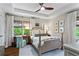 Inviting primary bedroom featuring tray ceilings, a ceiling fan, and large windows at 2336 Armand Ne Rd, Atlanta, GA 30324