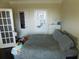 Cozy bedroom features a comfortable bed with a gray comforter, complemented by a dresser and closet at 3716 Derringer Rdg, Loganville, GA 30052