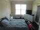 Bright bedroom features a comfortable bed, dresser, and a window allowing natural light to fill the space at 3716 Derringer Rdg, Loganville, GA 30052