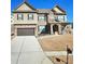 Charming two-story home featuring a brick and siding facade, attached garage, and well-manicured lawn at 3716 Derringer Rdg, Loganville, GA 30052