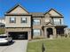 Charming two-story home featuring a brick and siding facade, attached garage, and well-manicured lawn at 3716 Derringer Rdg, Loganville, GA 30052