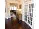 Inviting foyer featuring hardwood floors, a wooden console table, and a view into the adjacent living room at 3716 Derringer Rdg, Loganville, GA 30052