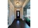 Stunning foyer with dark hardwood floors and view of the front door at 3716 Derringer Rdg, Loganville, GA 30052