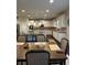 Spacious kitchen with white cabinetry, granite countertops, stainless steel appliances, and a large island at 3716 Derringer Rdg, Loganville, GA 30052