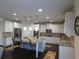 Spacious kitchen with white cabinetry, granite countertops, stainless steel appliances, and a large island at 3716 Derringer Rdg, Loganville, GA 30052