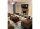 Inviting living room with a stone fireplace, plush seating, and a stylish area rug creating a cozy atmosphere at 3716 Derringer Rdg, Loganville, GA 30052