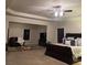 Large main bedroom featuring a sitting area, a ceiling fan, carpet, and ample natural light at 3716 Derringer Rdg, Loganville, GA 30052