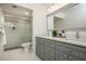 Modern bathroom with double vanity, shower, and gray shaker cabinets with quartz countertops at 39 Ivy Gates Ne, Atlanta, GA 30342