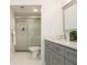 Modern bathroom featuring a shower, toilet, and gray shaker cabinets with quartz countertops at 39 Ivy Gates Ne, Atlanta, GA 30342