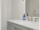 Close up of a bathroom with modern faucet fixtures, white countertops, and mint cabinets at 39 Ivy Gates Ne, Atlanta, GA 30342
