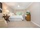 Well-lit bedroom with soft carpet, a large window, and classic furniture for a relaxing and inviting space at 39 Ivy Gates Ne, Atlanta, GA 30342