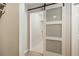 Modern closet with sliding glass door, built-in shelves, and ample storage space for organized living at 39 Ivy Gates Ne, Atlanta, GA 30342