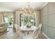 Dining room featuring decorative lighting, neutral paint, and a beautiful view of trees at 39 Ivy Gates Ne, Atlanta, GA 30342