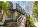 Exterior elevation featuring wood stairs, multi-pane windows, and lush landscaping at 39 Ivy Gates Ne, Atlanta, GA 30342