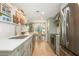 Modern kitchen features stainless steel appliances, light cabinetry with gold hardware, and a view to the dining area at 39 Ivy Gates Ne, Atlanta, GA 30342