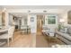 Open concept living room featuring a modern kitchen, light hardwood floors, and decorative artwork at 39 Ivy Gates Ne, Atlanta, GA 30342
