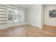 Bright living room featuring hardwood floors, built-in bookshelves, and ample natural light from large window at 39 Ivy Gates Ne, Atlanta, GA 30342
