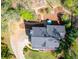 An aerial view of a beautiful home featuring a stone walkway, an outdoor seating area, and mature trees at 4520 Windsor Oaks Dr, Marietta, GA 30066