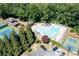 Aerial view of the community pool area featuring lounge chairs, tall trees, and tennis courts at 4520 Windsor Oaks Dr, Marietta, GA 30066